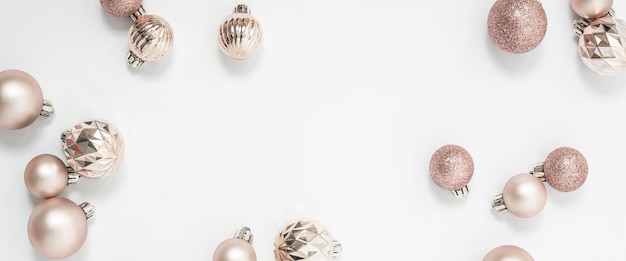 Mooie gouden decoratieve ballen op een witte achtergrond. Bovenaanzicht, plat gelegd. Banier.