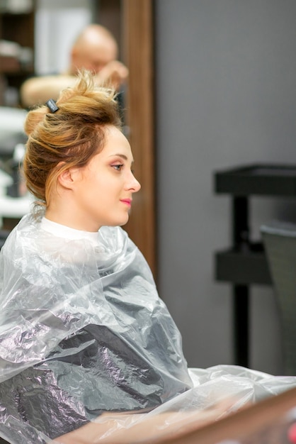 Mooie jonge blonde blanke vrouw in de moderne kapsalon