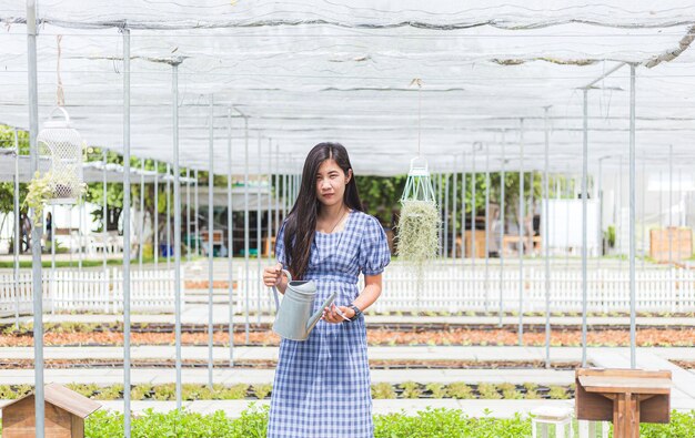 Mooie jonge tuinierende vrouw in een groene tuin