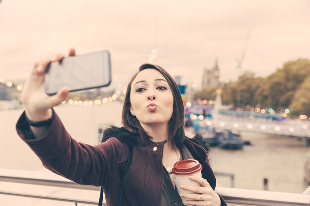 Mooie jonge vrouw die een selfie in Londen neemt