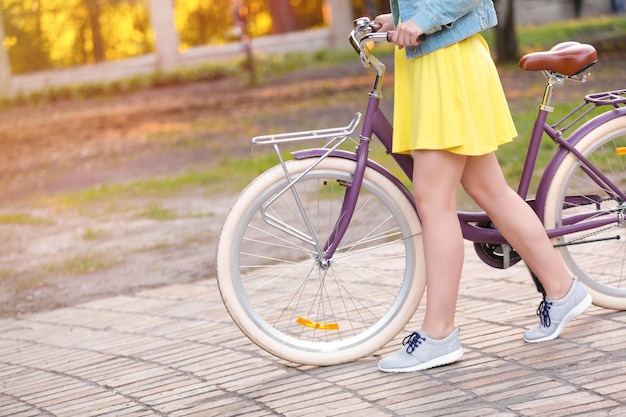 Mooie jonge vrouw met fiets buitenshuis