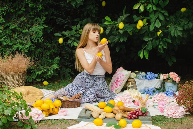 Mooie jonge vrouw op een picknick in de tuin