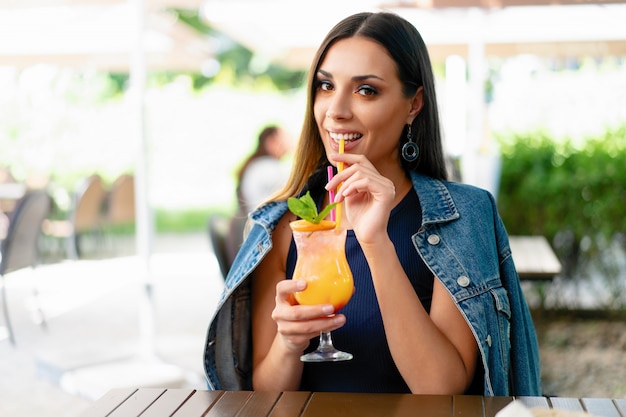 Mooie Kaukasische vrouw die een exotische de zomercocktail drinkt