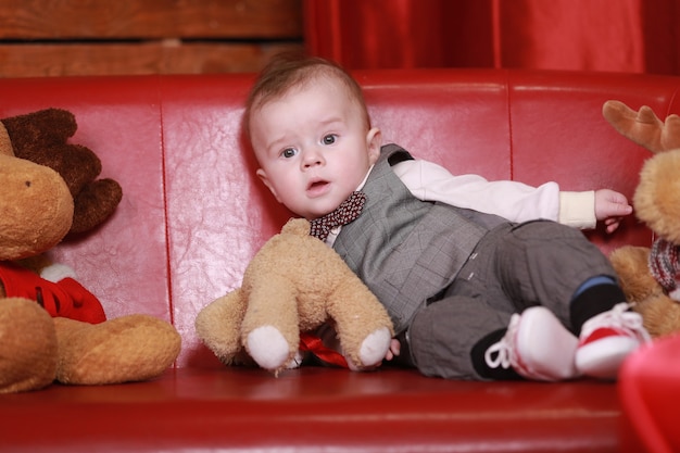 Mooie kleine babyjongen viert kerstmis. nieuwjaars vakantie. baby met cadeau.