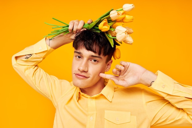 Mooie man met een boeket bloemen die onveranderd een cadeau-levensstijl voorstelt