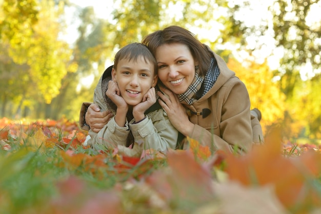 Mooie moeder met zoon in herfstpark