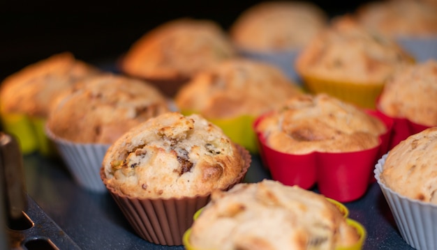 Mooie muffins in veelkleurige siliconenvormen worden in de oven gebakken