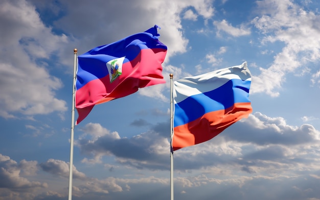 Mooie nationale vlaggen van Haïti en Rusland samen op blauwe hemel. 3D-illustraties