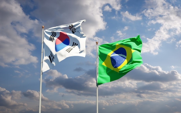 Mooie nationale vlaggen van Zuid-Korea en Brazilië samen op blauwe hemel