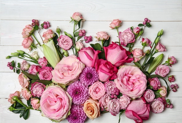 Mooie roze bloemen op witte houten tafel