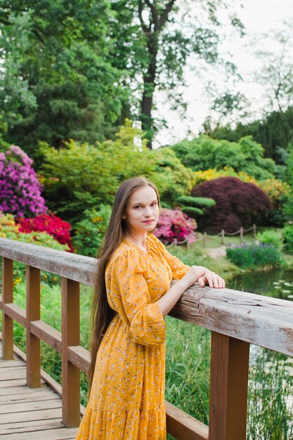 Foto mooie vrouw in de zomer in gele jurk