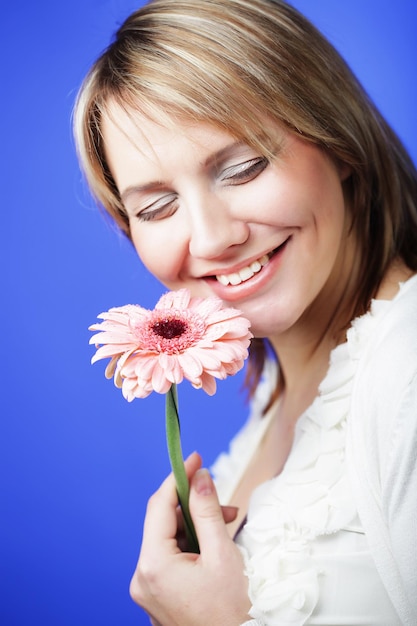 Mooie vrouw met grote roze gerber