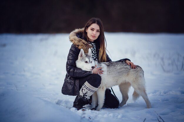 Mooie vrouw met Husky poseren in de winter