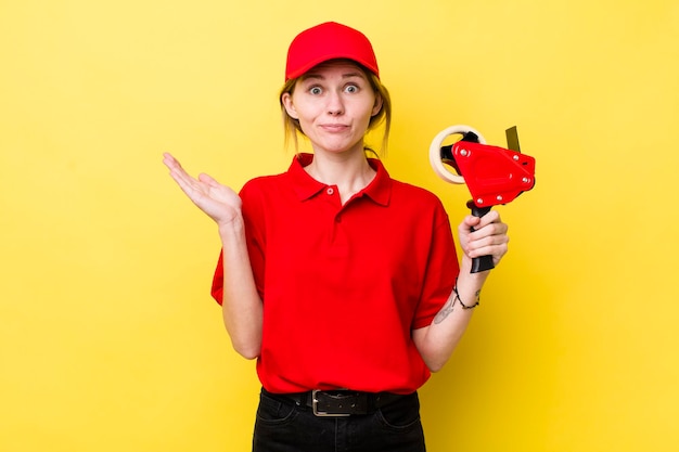 Mooie vrouw met rood hoofd die zich verward en verward voelt en twijfelt aan het concept van de verpakker