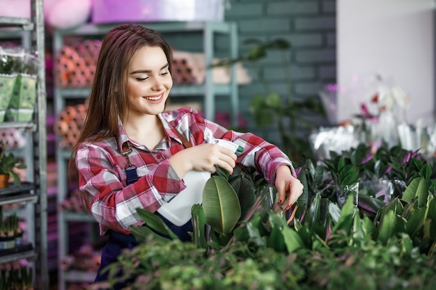 Mooie vrouw met spuitfles sproeiplanten