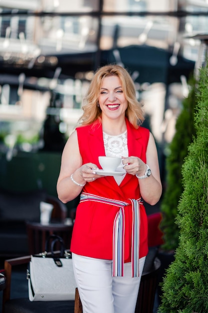 Mooie vrouw, vrouwelijke zakenvrouw poseren voor de camera met een kopje koffie