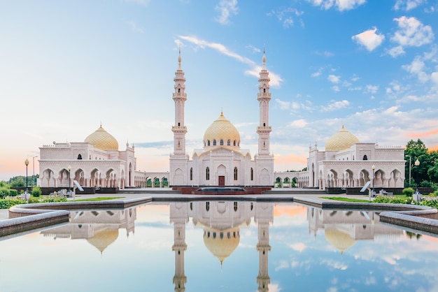 Mooie witte moskee met koepels en minaretten reflectie op het wateroppervlak