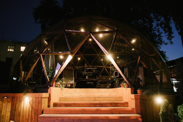 Mooie zomerse glazen cafébol 's nachts met verlichting