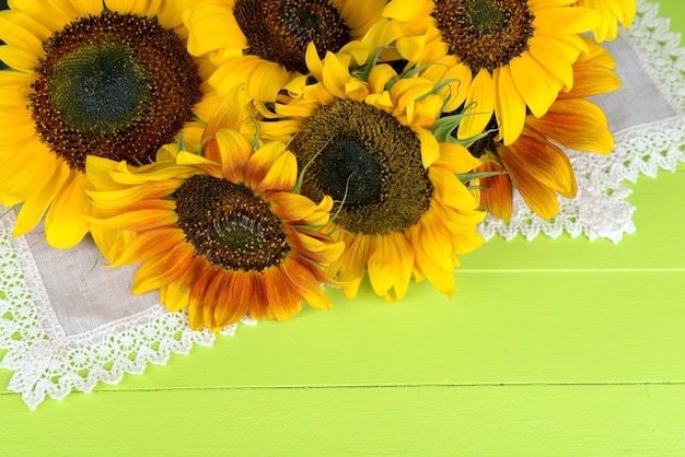 Mooie zonnebloemen in kruik op servet op tafel close-up