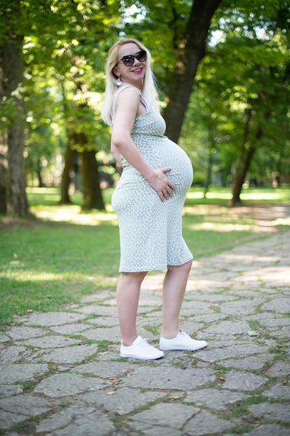 Mooie zwangere vrouw met buik buiten