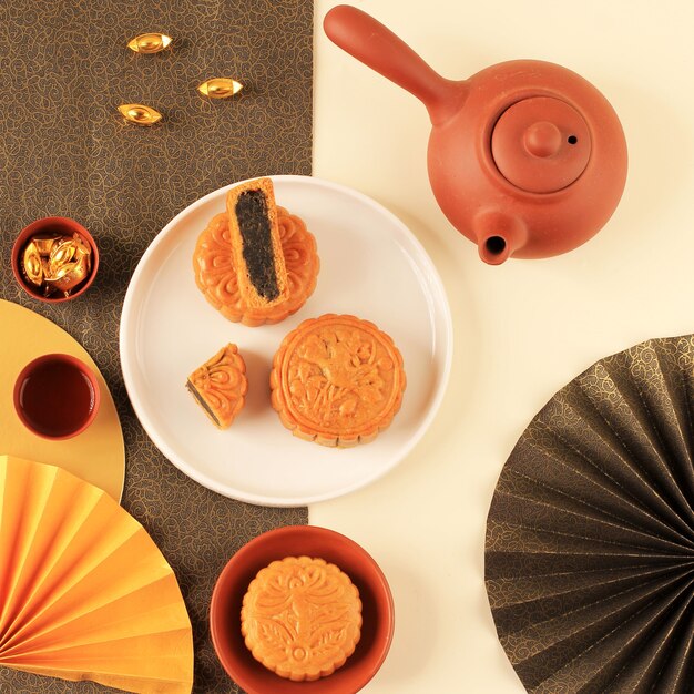 Moon Cake Chinese Dessert Snack during Lunar new year Mid Autumn Festival. Flatlay Concept with Yellow and Gold Theme. Copy Space for Text