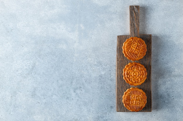 Moon cake chinese traditional pastry on a concrete background top view copy space