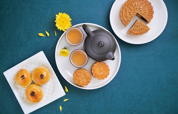 Moon cake for MidAutumn Festival delicious beautiful fresh mooncake on a plate over blue background table top view flat lay layout design concept