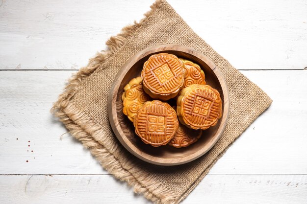 Moon cake Mooncake table setting - Round shaped Chinese traditional pastry with tea cups on a table.