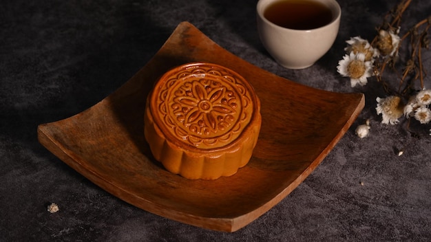 moon cake wooden plate decorating with dried flower mid autumn festival or chinese traditional festival