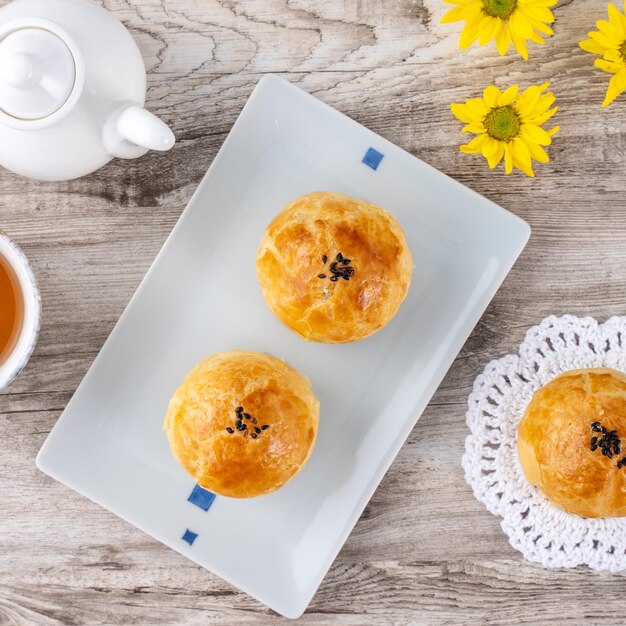 Moon cake yolk pastry mooncake for midautumn festival holiday\
top view design concept on bright wooden table with copy space flat\
lay overhead shot