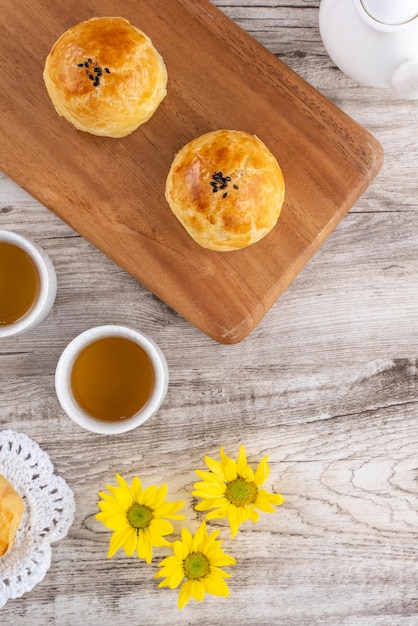 Moon cake yolk pastry mooncake for MidAutumn Festival holiday top view design concept on bright wooden table with copy space flat lay overhead shot