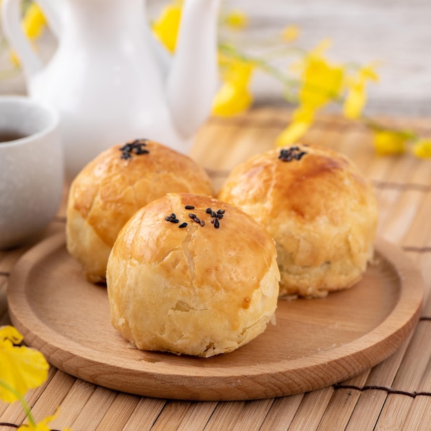 Moon cake yolk pastry mooncake for midautumn festival holiday\
top view design concept on bright wooden table with copy space