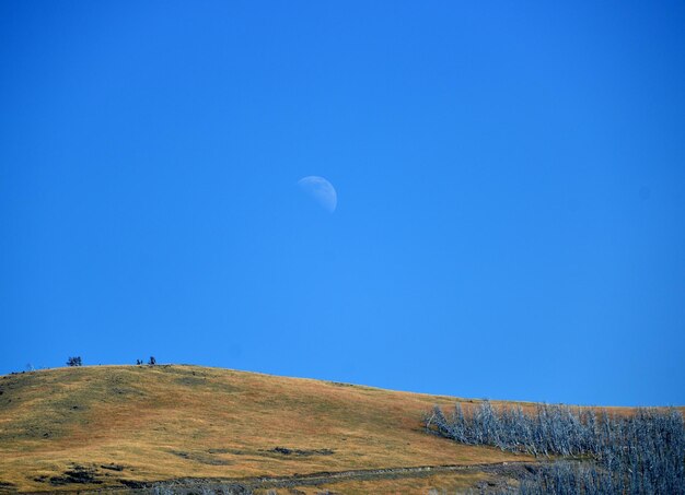 Moon above mountain in sky