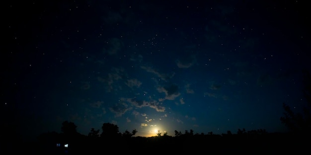 Moonset in the night sky with stars