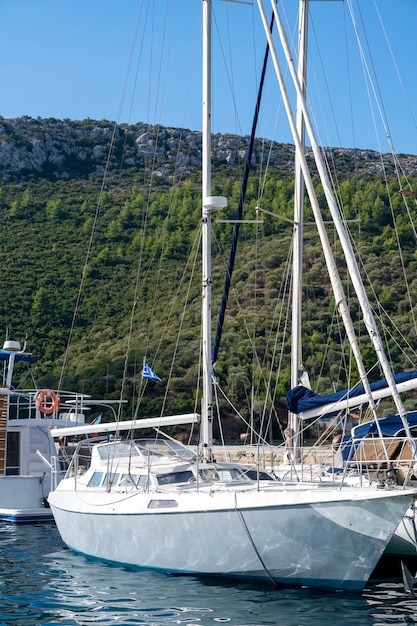 Moored boat on the pier in a village, a lot of greenery, green  Greece