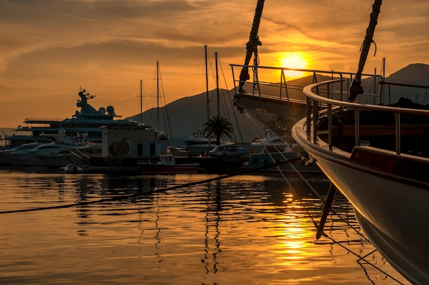 Moored yachts and motorboats at sunset