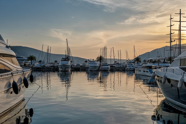 Moored yachts and motorboats at sunset