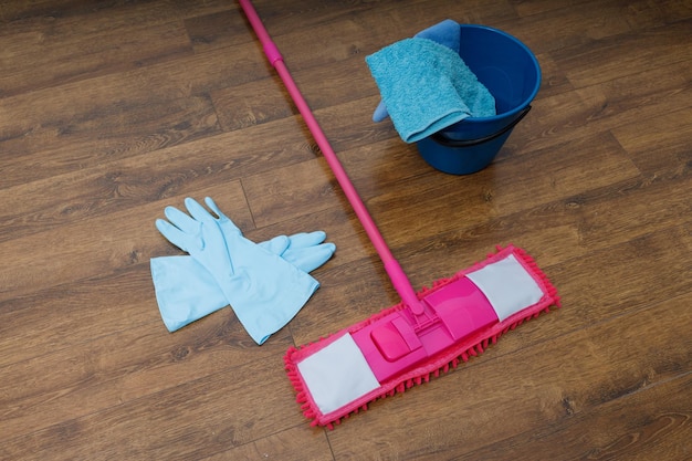 Photo mop gloves and bucket on the floor