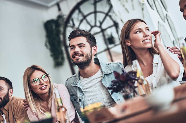 More laugh with friends. Group of young people in casual wear communicating and smiling 