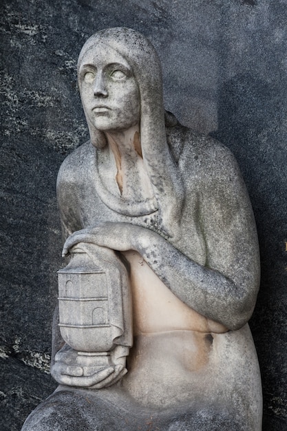 More than 100 years old statue. Cemetery located in North Italy.