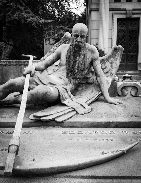 More than 100 years old statue. Cemetery located in North Italy.