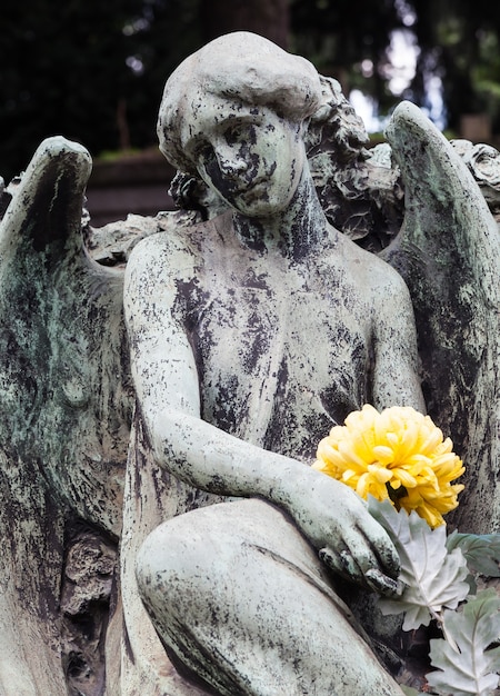 More than 100 years old statue. Cemetery located in North Italy.