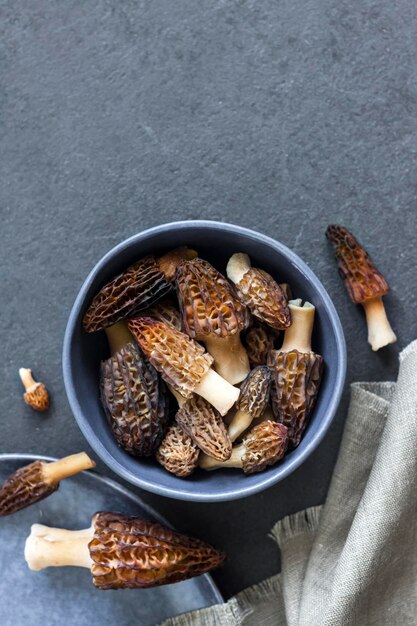 Morel mushrooms in a blue bowl Flat lay