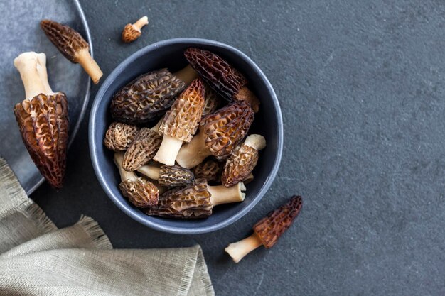 Morel mushrooms in a blue bowl Flat lay