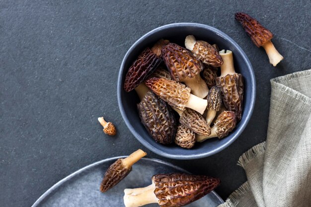 Morel mushrooms in a blue bowl Flat lay