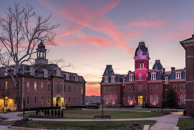 Morgantown WV 8 March Dramatic image of Woodburn Hall at West Virginia University or WVU in Morgantown WV as the sun sets behind the illuminated historic building