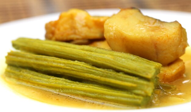 Moringa curry with fish on a plate