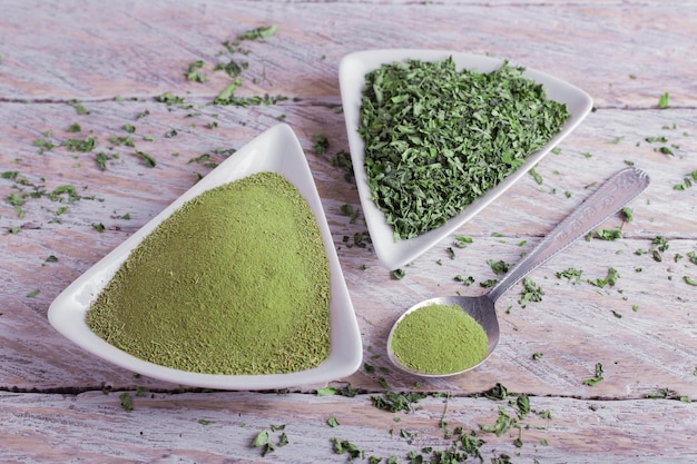 Moringa powder and leaves on wood