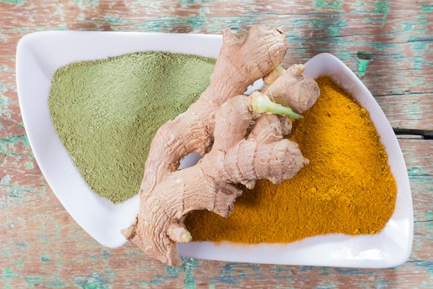 Moringa powder and turmeric with ginger root on the table