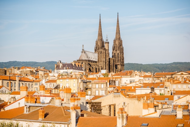 Morning aerial cityscape view on Clermont-Ferrand city with beautiful cathedral and mountains on the background in central France